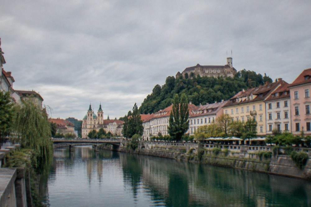Lake Bled in Slovenia with the church on the island and forested hills around the shore in morning light