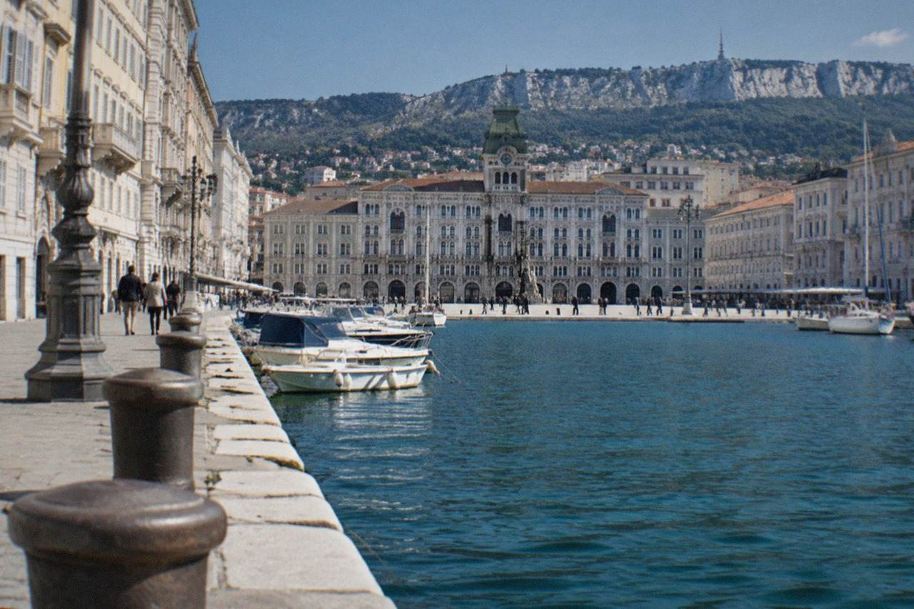 The wide seafront square of Trieste with the town hall and gulf in the background