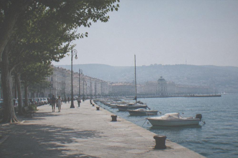 The Trieste seafront promenade with the city skyline and Adriatic sea