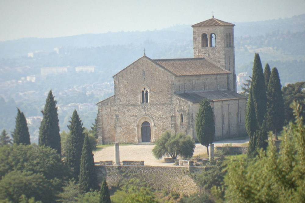 The façade of Trieste Cathedral on San Giusto hill with its bell tower behind