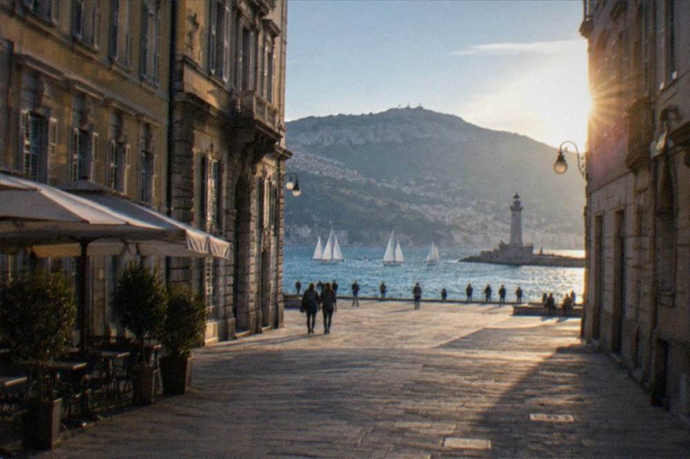 The Trieste gulf with sailboats and the lighthouse on the shoreline