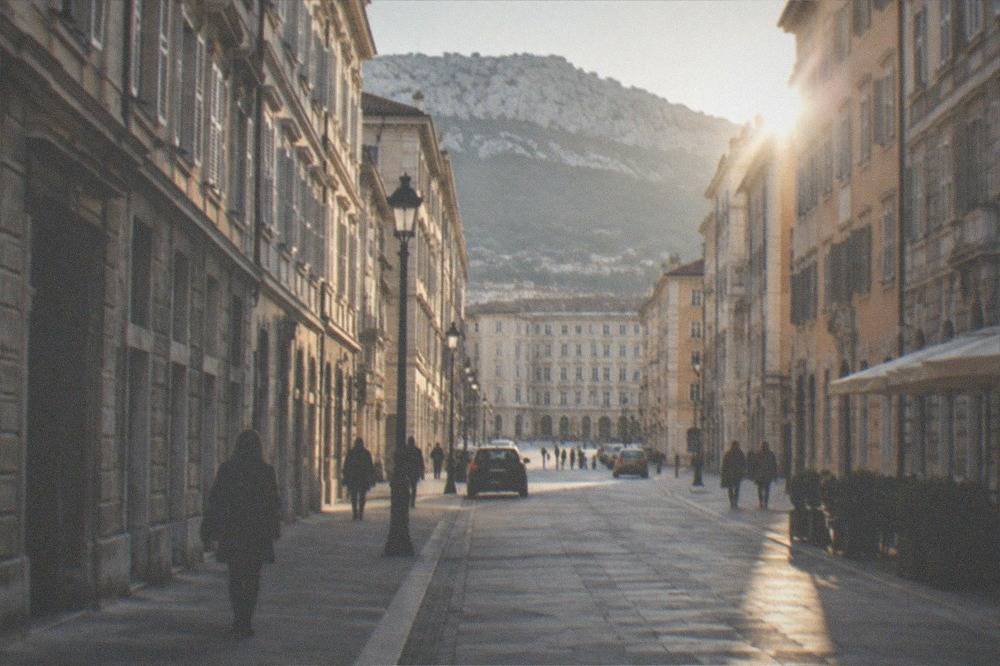 A straight grid street in central Trieste with even paving and modest traffic