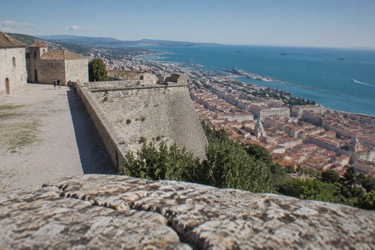 Panoramic view over Trieste in Italy from San Giusto hill with the city rooftops and the Adriatic sea beyond
