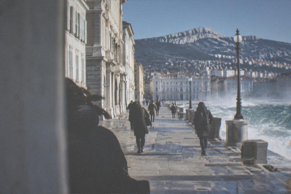 Waves breaking along the Trieste seafront under a strong bora wind with spray over the promenade