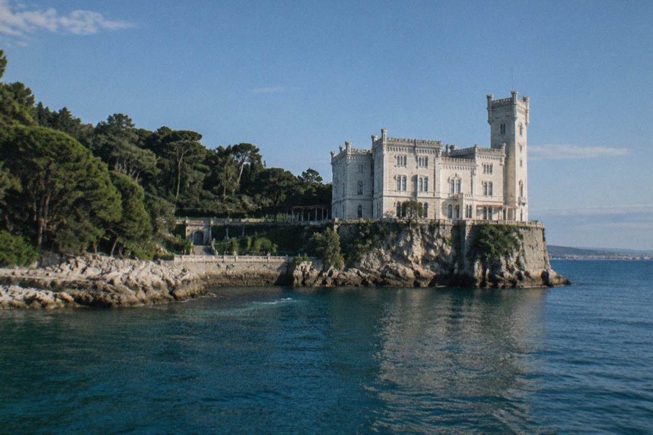 The white limestone walls of Miramare Castle rising above the sea on a clear morning near Trieste