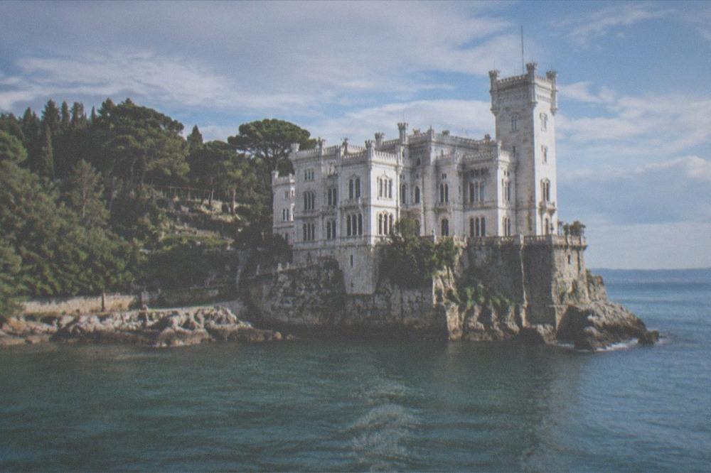 The white facade of Miramare Castle above the sea near Trieste