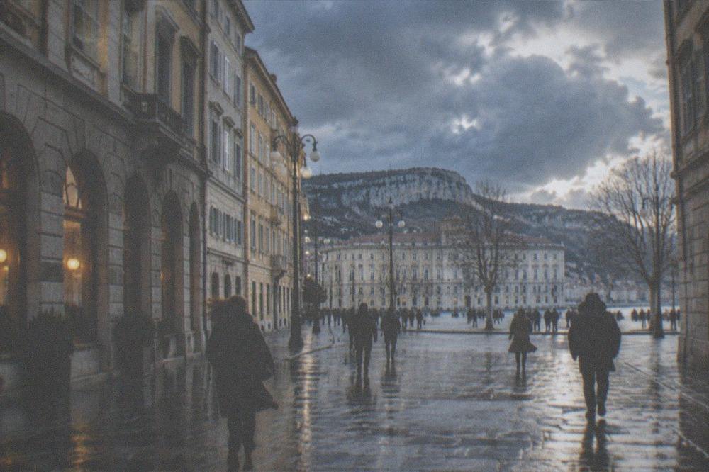 A rainy winter evening in Trieste with lit windows of an old eating house and wet cobblestones