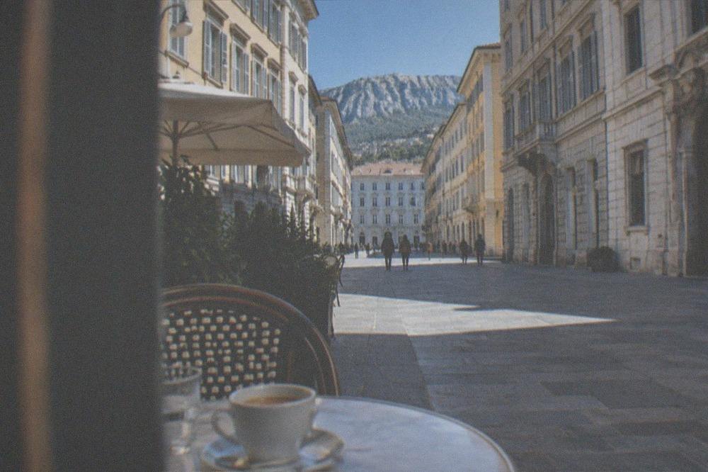 An espresso cup on a marble table in an ornate historic cafe in Trieste