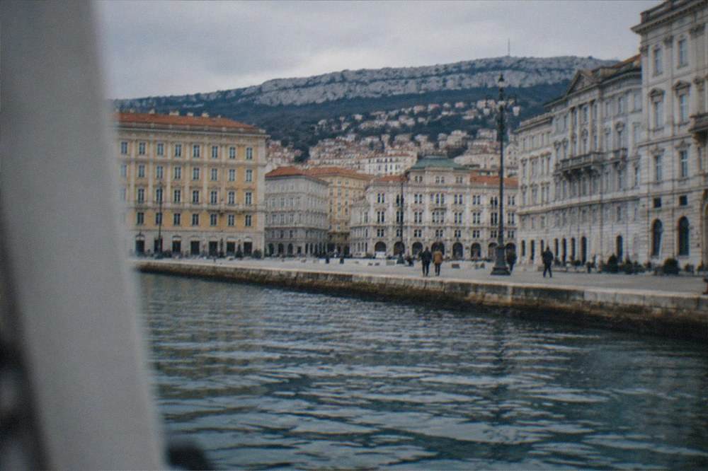 The seafront quays of Trieste seen from the water with the city's neoclassical facades along the shore