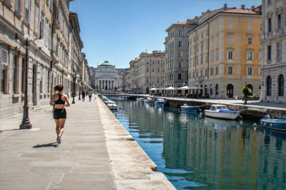 An elegant European city square with neoclassical buildings and a wide open paving of stone
