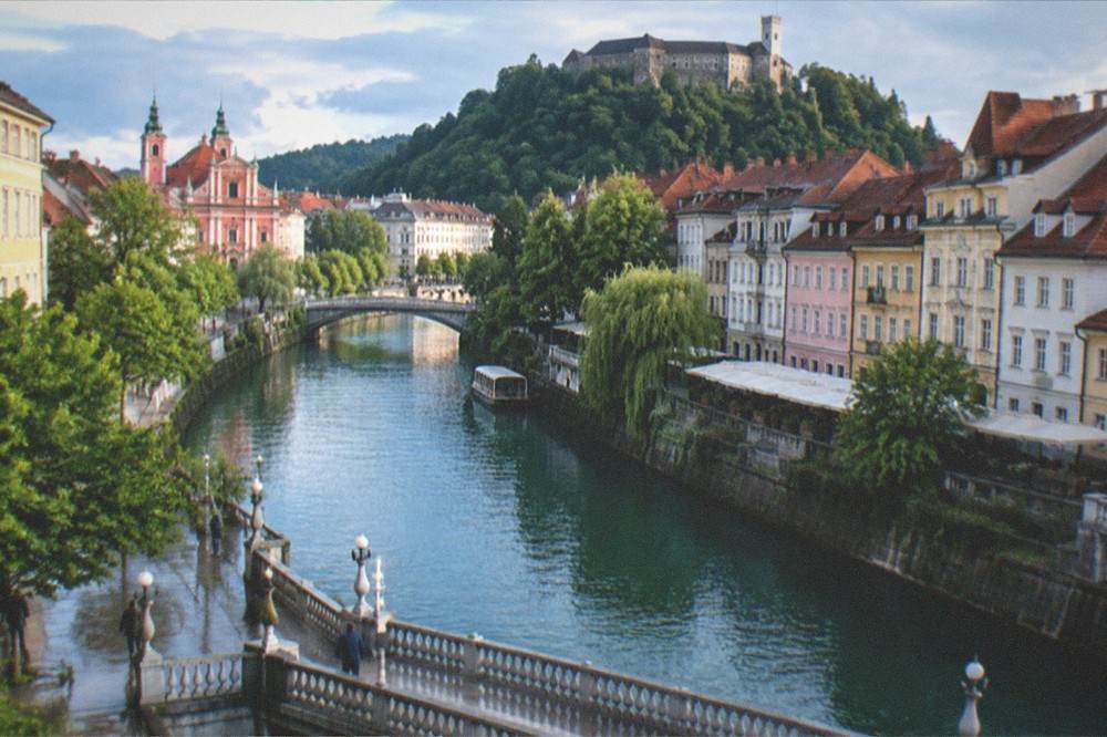 Ljubljana's riverside old town with its bridges and the castle hill in the background