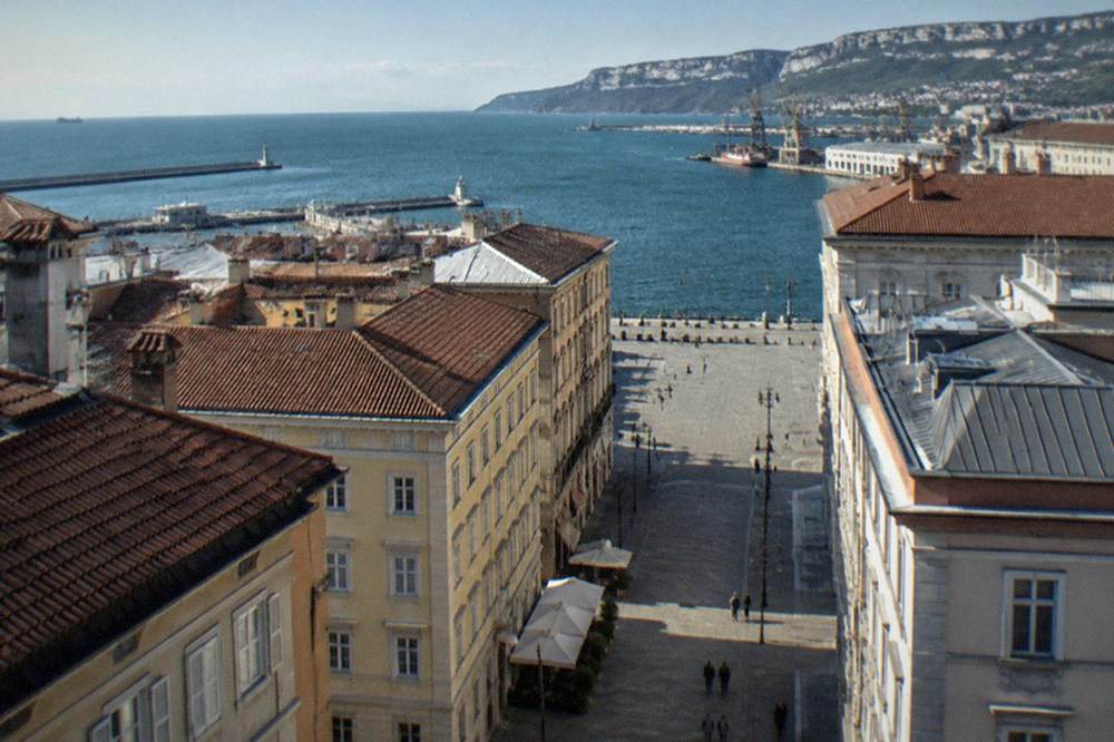 View over rooftops of Trieste toward the Adriatic sea from a high terrace