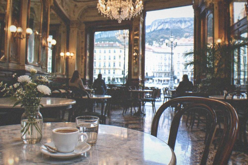 Interior of a historic Trieste cafè with marble tables and chandeliers