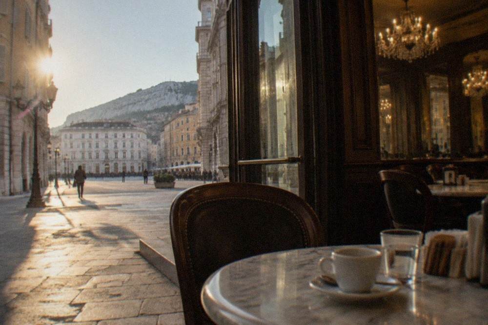 A historic Trieste caffè interior with marble tables and chandeliers