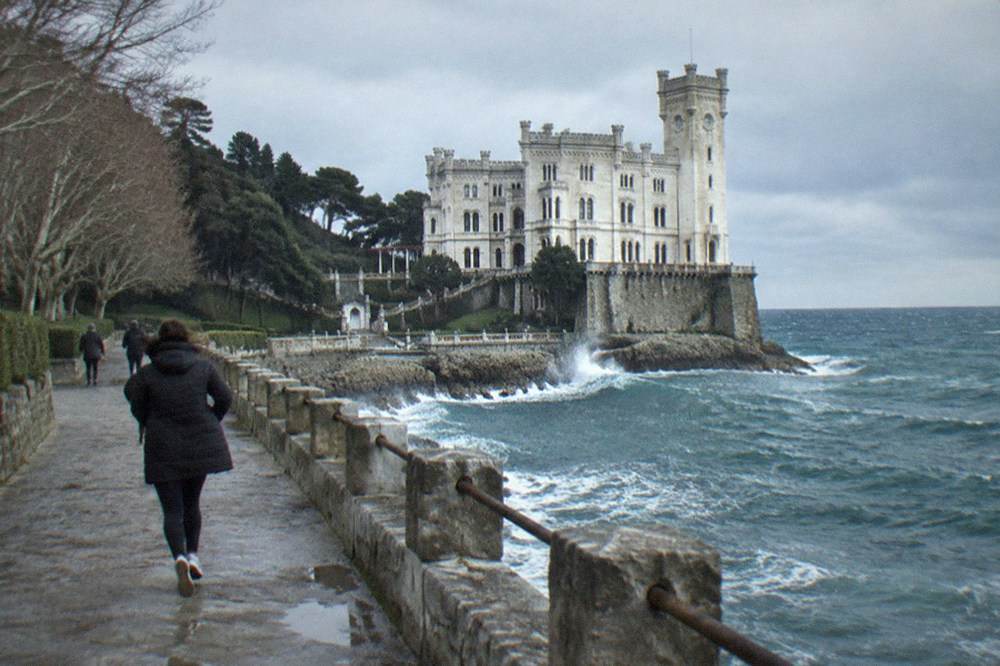The white cliffside facade of Miramare Castle above the winter Adriatic